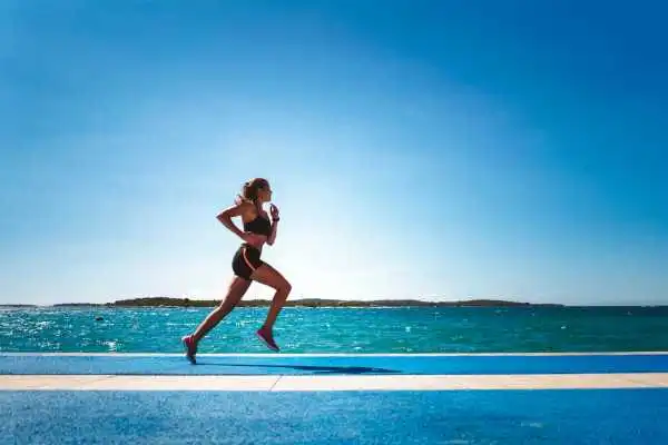 Woman running showing strong leg muscle Bexleyhill